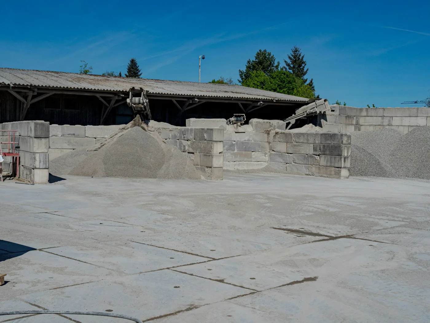 Piles of gravel and concrete blocks at a construction site