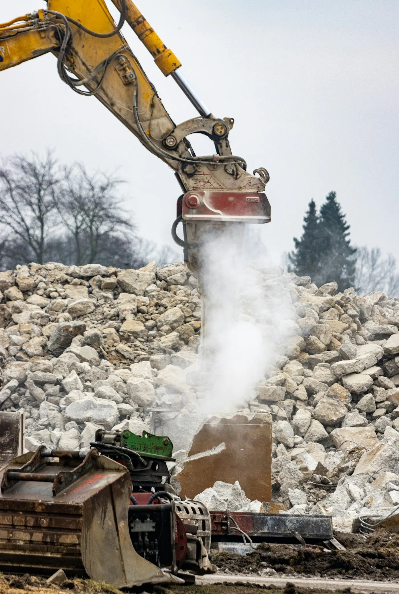 Excavator and pile of rubble at a construction demolition site