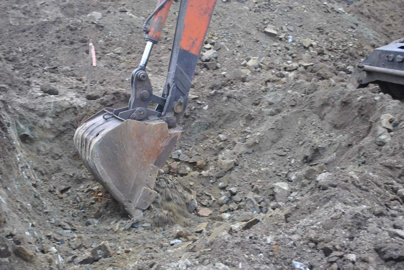 Bulldozer moving through a pile of dirt on a jobsite
