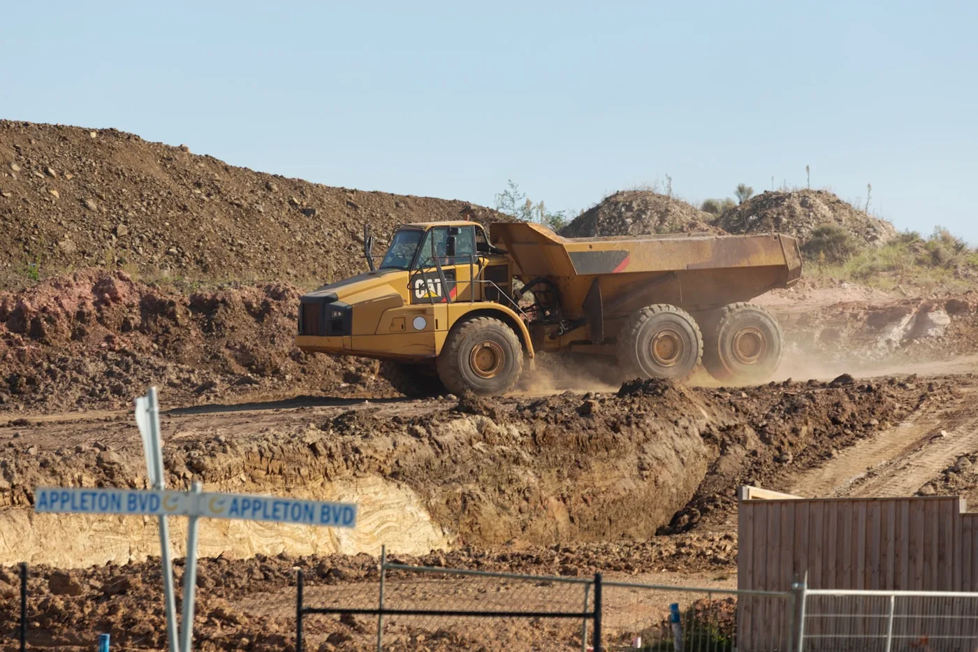 Dump truck transporting dirt at a construction site