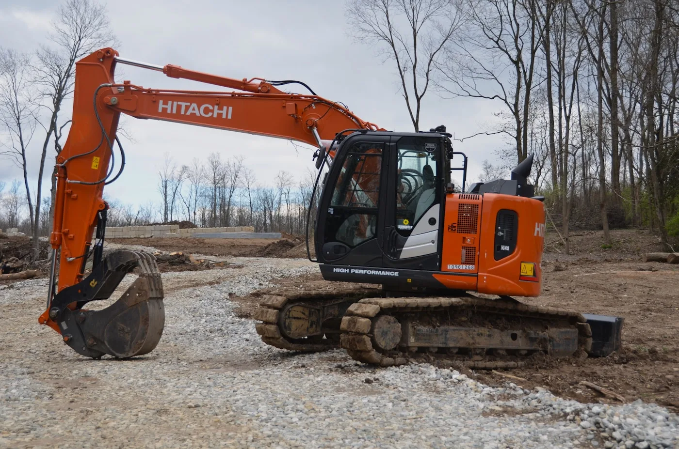 Excavator on a pile of dirt at a jobsite