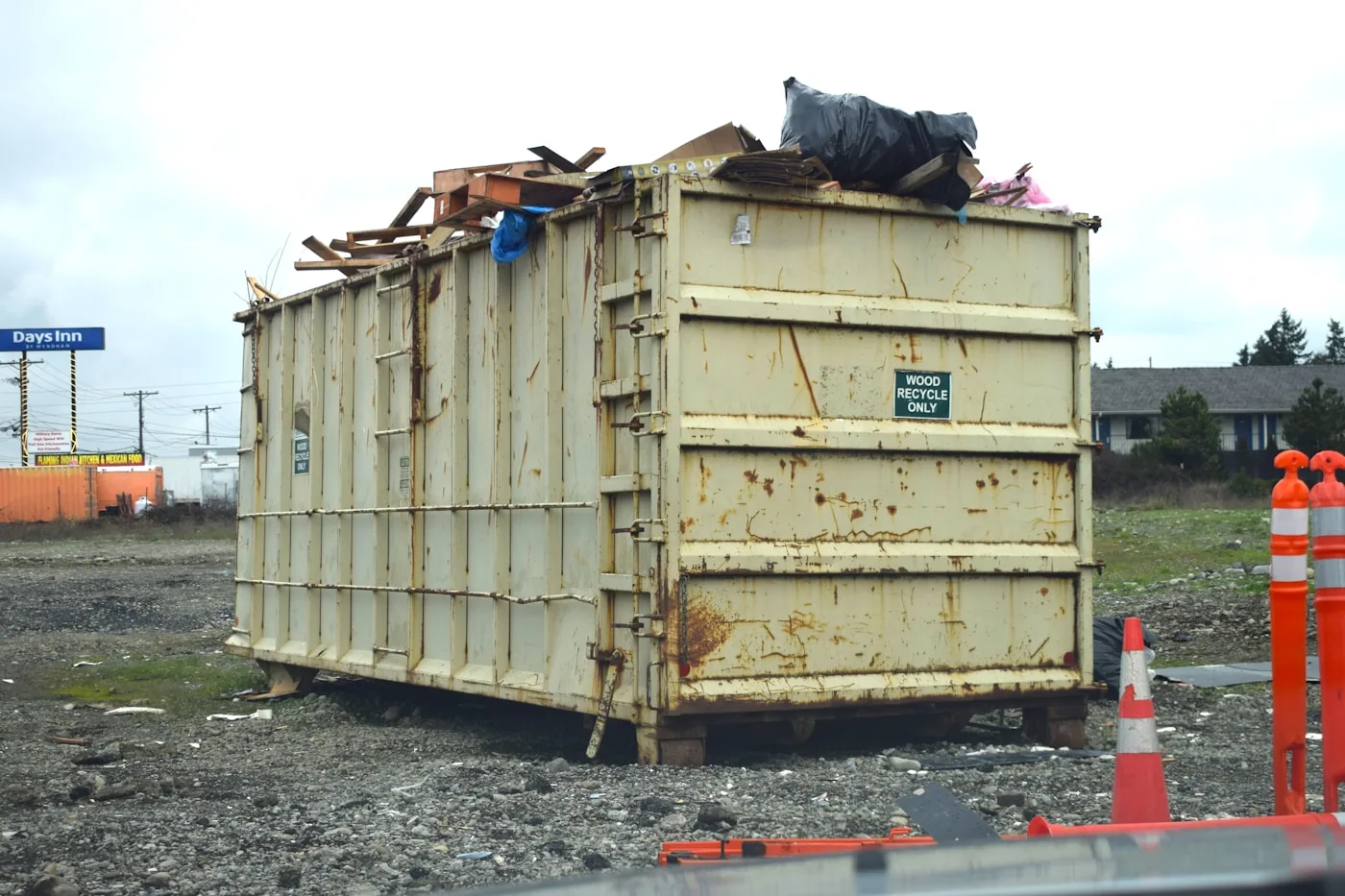 Rolloff dumpster sitting on a pile of construction rubble